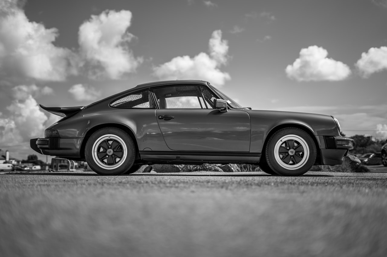 Classic Porsche 911 on a road, showcasing the iconic rear-engined sports car silhouette