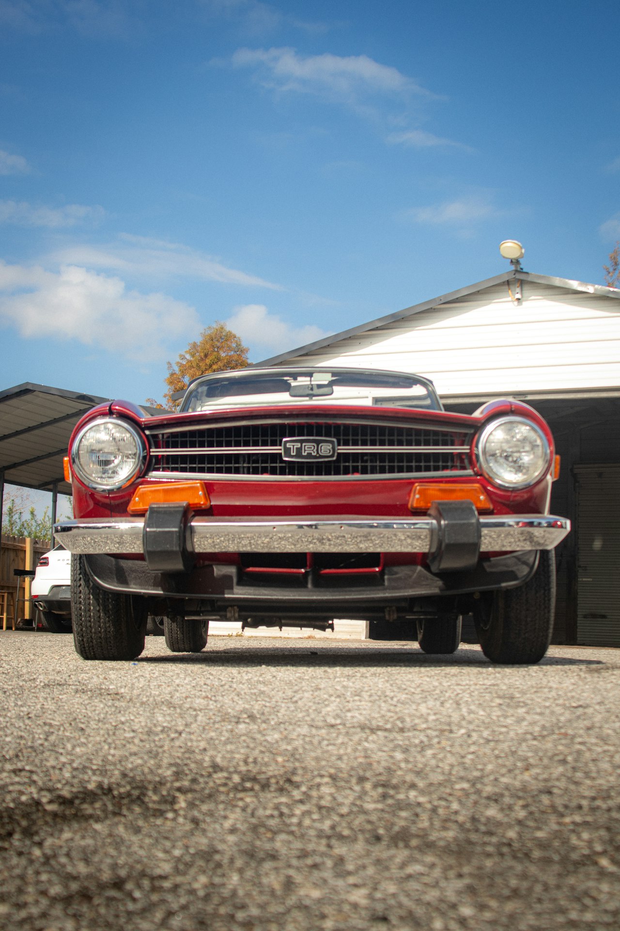 Classic red Triumph TR6 roadster, front view showing the Karmann-designed body